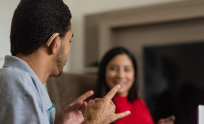 A deaf person exchanging with a colleague in sign language